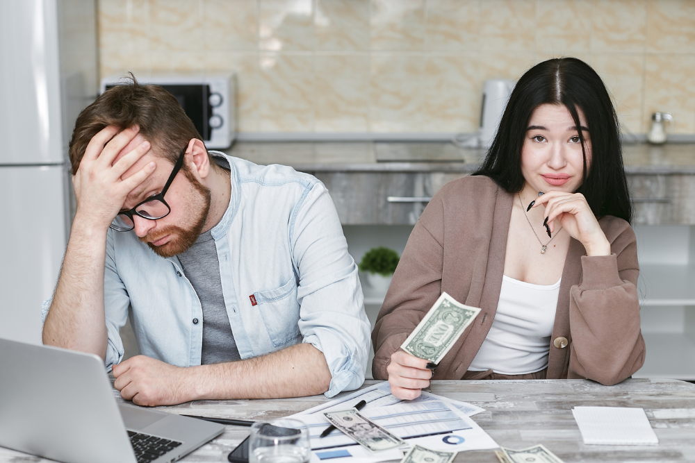 Worried couple reviewing budget